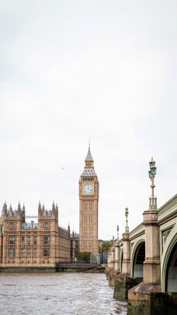 Photo by Greace Xaveria on Unsplash Parliament and Big Ben from across the other side of the river, showing the bridge on the right hand side.