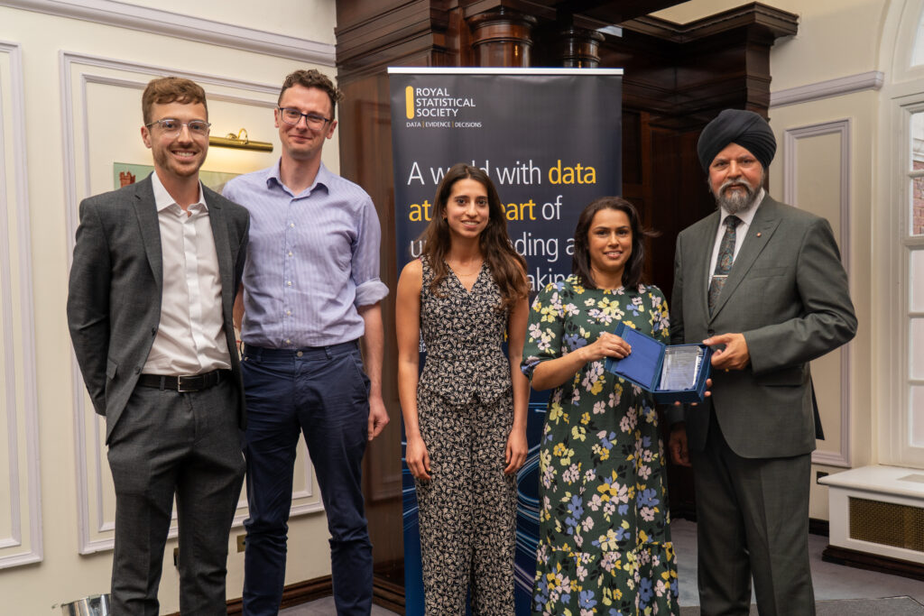 A photo of the winning team with their award.