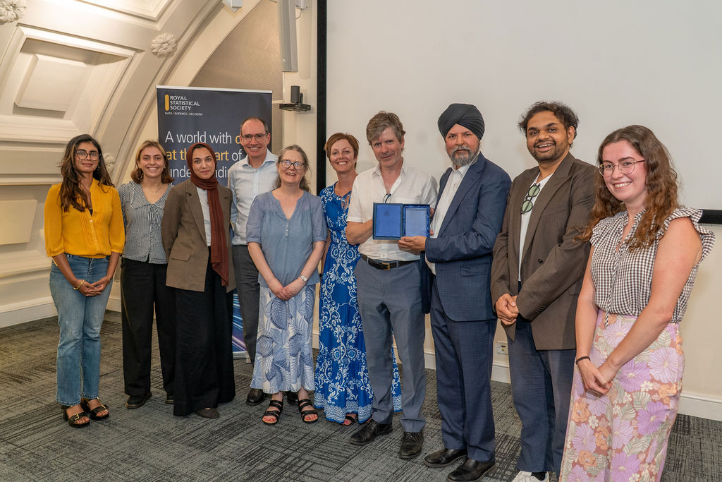 A photo of the winning team with their award.